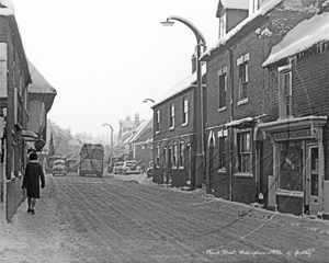 Snowy Peach Street, Wokingham in Berkshire c1970s  The overhangs are visible to the left and the houses and shops on the right are now gone