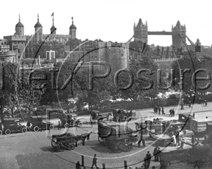 The Tower of London with Tower Bridge in the distance, together with a rank of cabs outside in London c1910s