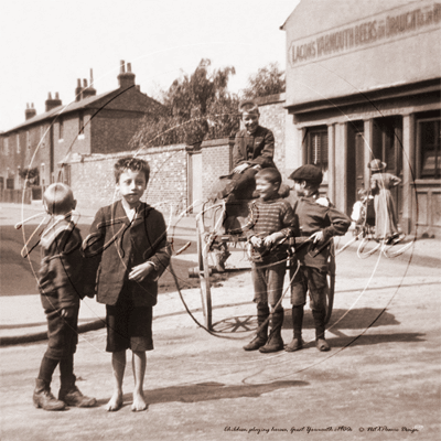 Kids playing horses in a street in Great Yarmouth in Norfolk c1900s